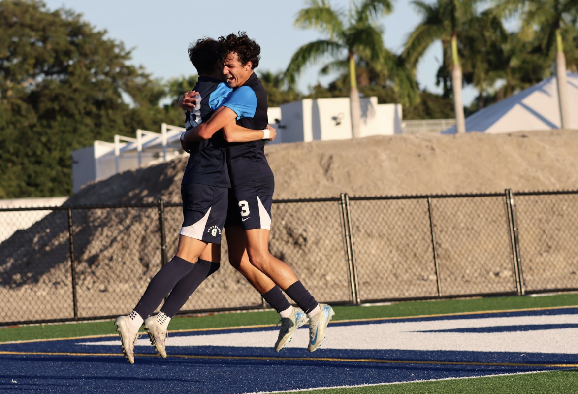 Senior Defender Chris Murciano celebrates with sophomore Lennox Millstein after a clutch goal. The goal put the Raider's ahead 2-1 with five minutes left of extra time, and put the finishing touch on the teams sixteenth win of the season.